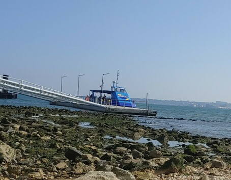 Photo of a boat on a river in Lisbon, Portugal. The boat is called Lisboat. 