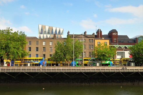 a colourful view across the Liffey towards buildings along the north wall