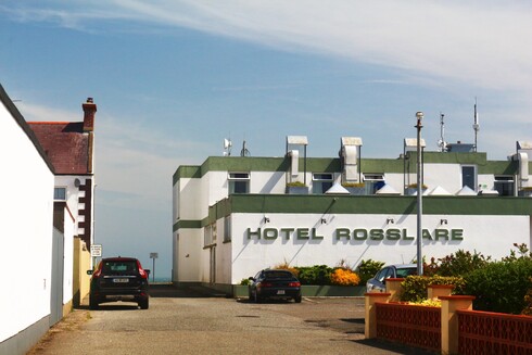 Rosslare Harbour hotel as seen from the back. the name HOTEL ROSSLARE is a fantastic modern typeface, green on white