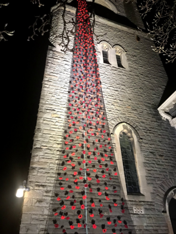 Picture of poppies on the side of the church in Radyr. Shot at night.