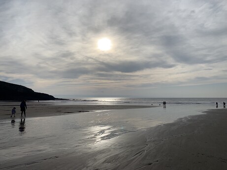 Low autumn sun reflects on the sea and sand at Southerndown