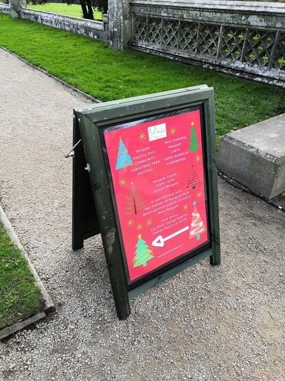 A-board sign pointing the way to the Margam Community Christmas Tree Festival.