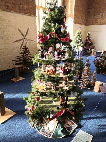 Tree by Neath Little Theatre, made from a stack of circular platforms, on which were several dioramas from Charles Dickens' A Christmas Carol.