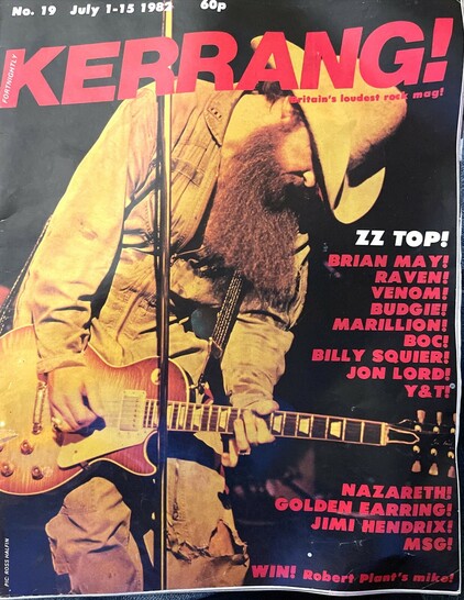 Issue 19 of Kerrang! Magazine, July 1982, with a fullpage cover image of Zz Top’s Billy Gibbons, wearing battered overalls, a cowboot hat, and playing a Gibson Les Paul (Goldtop, I think)