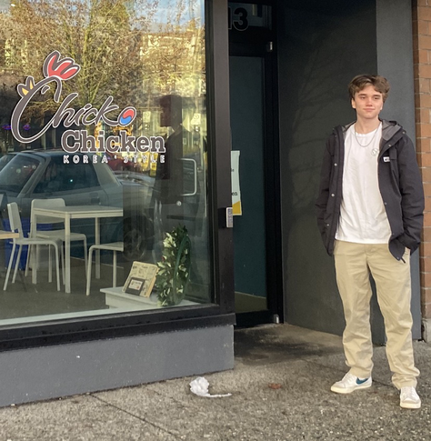 Teenager standing in front of a Korean fried chicken restaurant in North Vancouver 