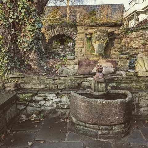 Various stone sculptures set in a wall.