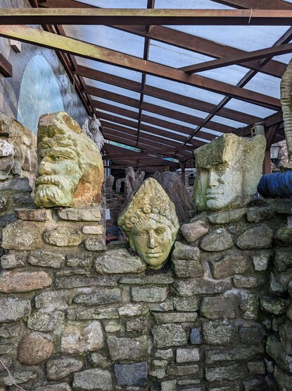3 stone carved heads.