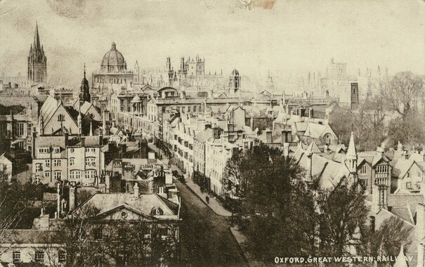 Old postcard of Oxford. The monochrome photograph shows an urban scene with a variety of college buildings, most medieval or pretending to be so. Lots of rooftops and towers, and a few trees. Printed on the bottom right of the card is "Oxford, Great Western Railway"