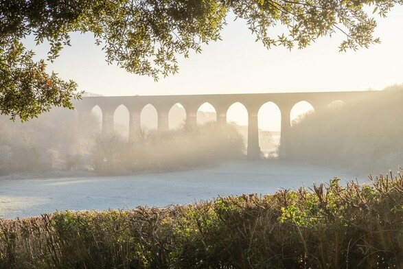 Hazy warm morning light shining through the viaduct in Barry.