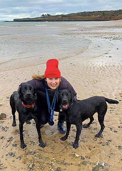 Two black labs and my lovely wife on beach in Anglesey