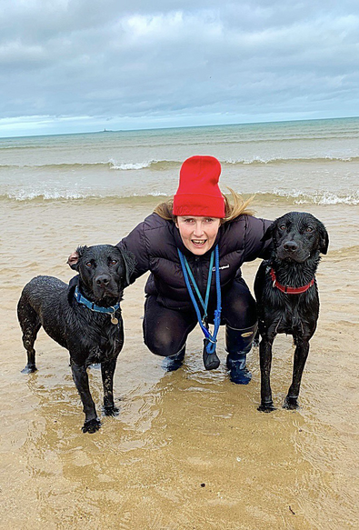 Two black labradors and my lovely wife on a beach in Anglesey