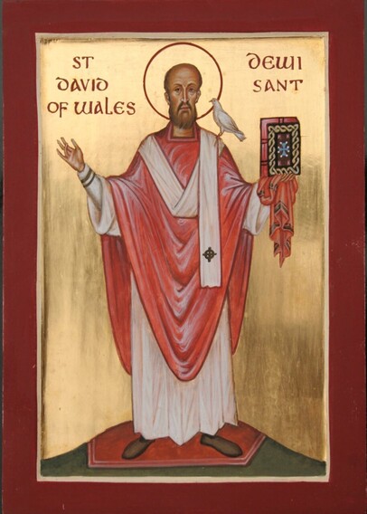 Image of Dewi Sant / St David, made as an icon. He holds the Bible in one hand;  a white dove is perched on his shoulder. He stands on a small mound. 