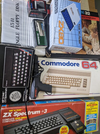 A collection of vintage (and reproduction) boxed computers and accessories. Including: ZX Spectrum +3, Commodore 64C, Sinclair ZX Spectrum, Sinclair ZX80, 1541 Floppy Disk, Memopak 16k, 16k ZX Memory Expansion for ZX81, Dragon 32, and a ZX Spectrum Lightgun.
