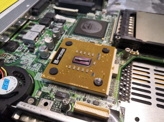 AMD Athlon laptop CPU with fresh thermal paste applied to the die.