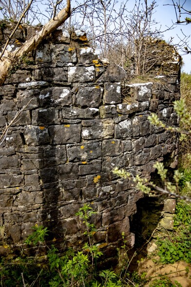 As I moved around the windmill, a large ,roughly circular hole could be seen at the base of the circular wall