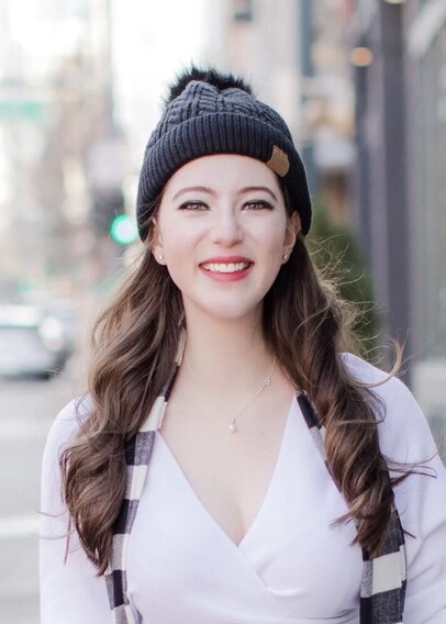 Picture of a young woman with long hair, wearing a hat