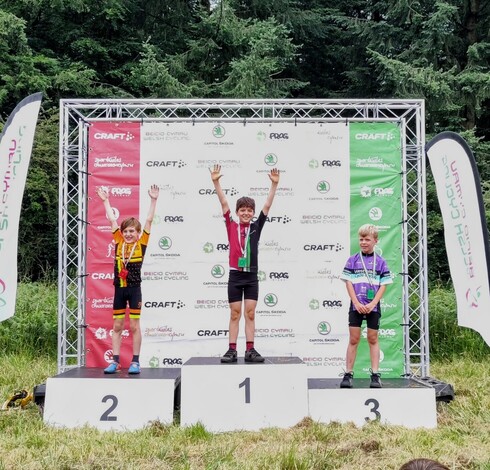Three boys on the podium of a bike race