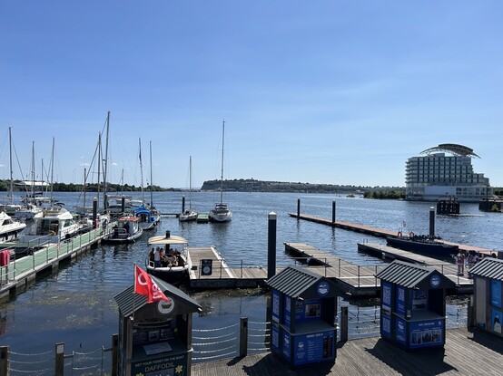 View across Cardiff Bay with pontoons and boats in the foreground and St David’s Hotel in the distance 
