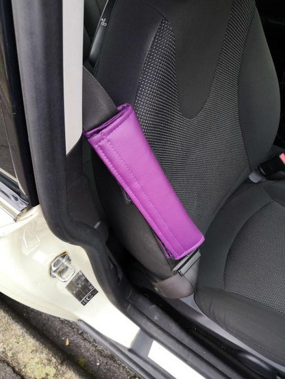 Interior of a Mini One, with a purple padded seatbelt cover.