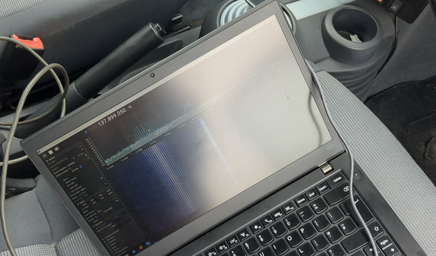 My laptop on my car seat showing the reception of a NOAA APT signal on 137MHz. The software is SDR++ 