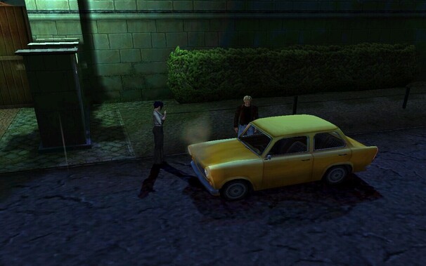 A screenshot from Broken Sword 3: The Sleeping Dragon in which two characters (Nico Collard, a French brunette, and George Stobbart, a blonde American man) are standing besides a yellow Trabant. The car is smoking from the engine.