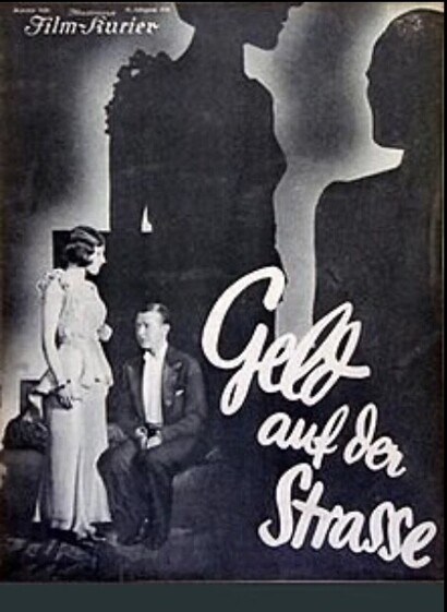 Woman standing, man sitting, shadows in the background 