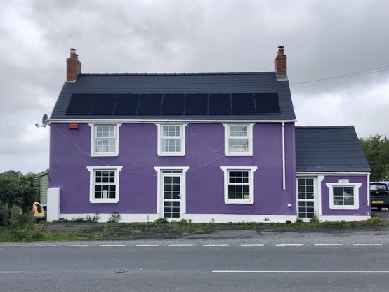 Stunning purple house overlooking the road. 