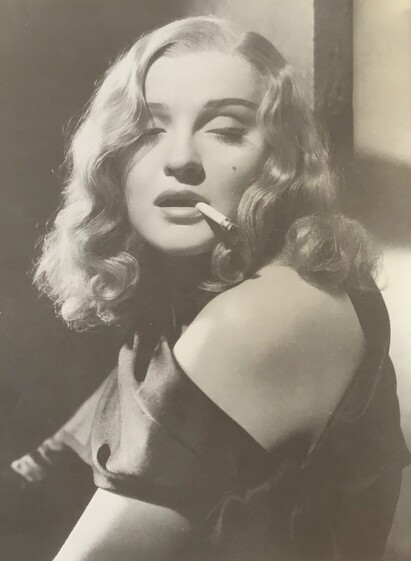 Actress with a cigarette stuck to her lips 