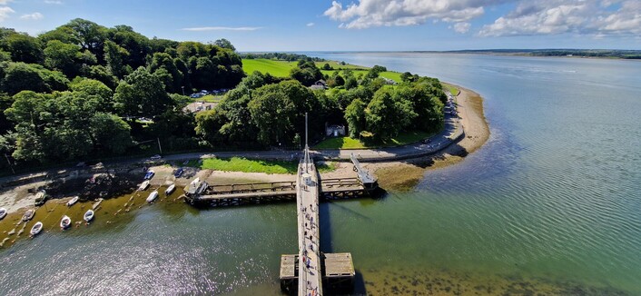 An view from The Eagle Tower at Caernarfon castle looking down to the swing-bridge going over the Arfon river.