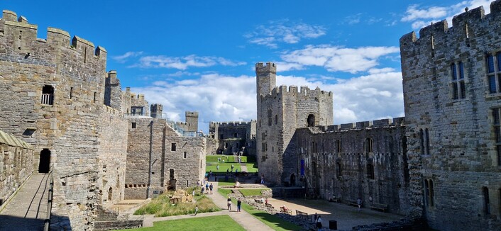 The inner grounds of Caernarfon castle showing its many towers.