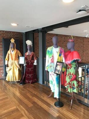 Four mannequins wearing theatre costumes. 