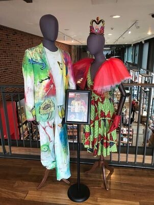 Two mannequins wearing theatre costumes from the RSC production of Hamlet. There is a sign with Paapa Essiedu that reads, "Hamlet - 2016".