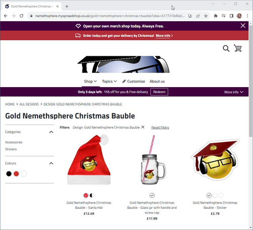 My merch store, showing a Santa hat, glass drinks jar with handle and straw, and sticker, all with the golden Nemethsphere bauble design (a bauble with a mortarboard graduation cap, headphones, and glasses.