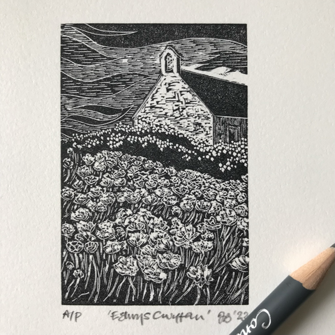 A black and white wood engraving of a small barn-like church seen from the bell-tower gable end.  The church sits high and off right in picture and above a sea of flowers.  The sky above is heavily stylised, with wavy forms of black through greys mirroring the wavy form of the flowers