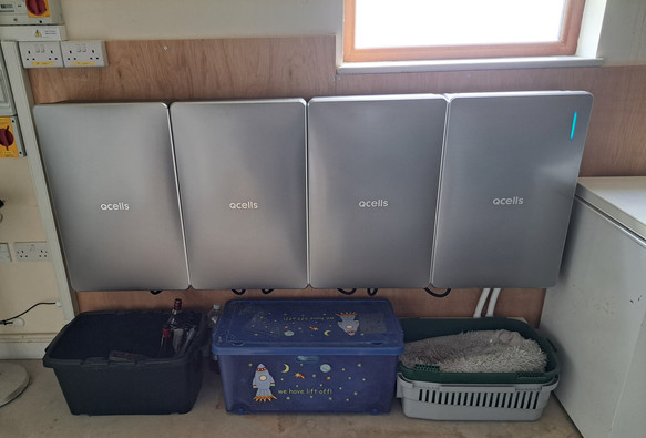 A set of storage batteries mounted on a garage wall. 