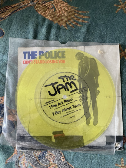 Yellow flexi-disc by The Jam in front of a Can’t Stand Losing You but the Police cover