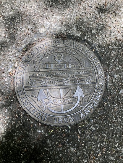 A bronze plaque at the start of the walk commemorating the train line 