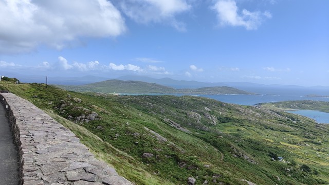 Looking again from a roadside view point over rocky fields making their way down to the coast. There's various headlands sticking out into the water.