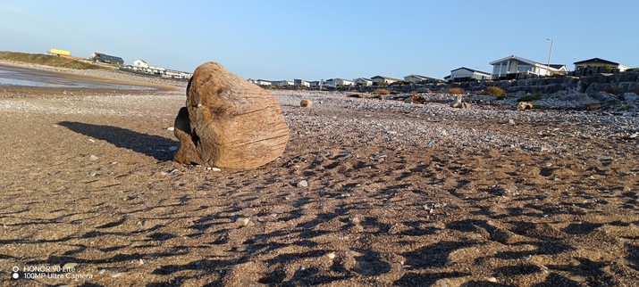 A solitary rock on the sand at Trecco Bay Beach