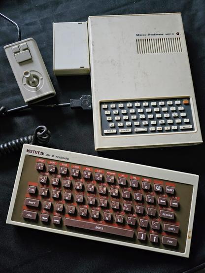 An image of a Multitech Micro-Professor II (MPF-II) with an external keyboard, joystick and cartridge.