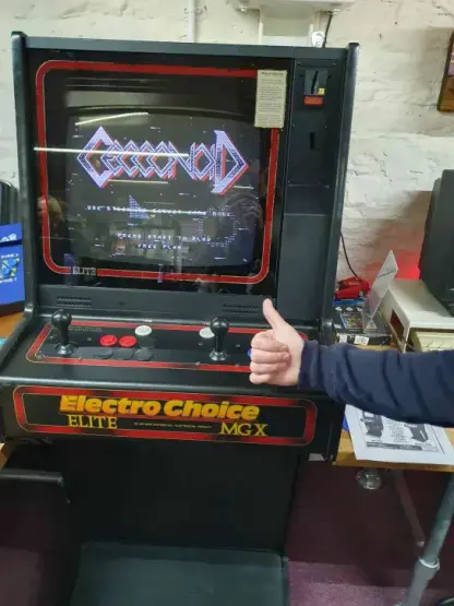 @klord's game Cecconoid had been ported to an obscure Amiga-based arcade cab from the mid to late 1980s which had been painstakingly restored by the RMC crew over the last few months, and it was on display for people to see and play. Here we can see the cab and the creator's thumb.