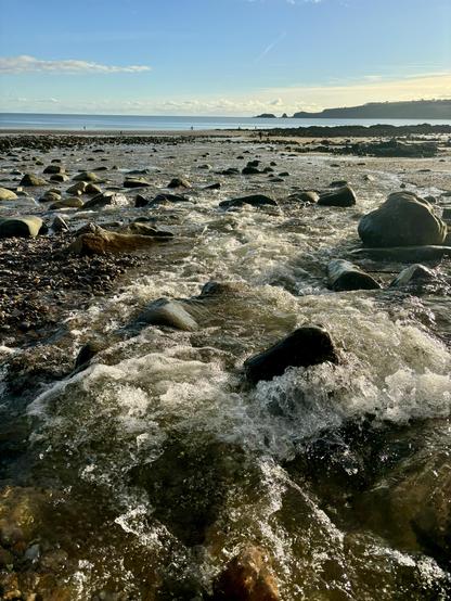 Small brook bubbly into the beach 