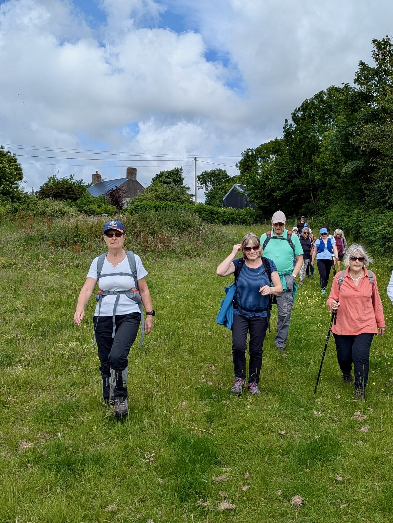 Walkers striding down into the valley from Hendre