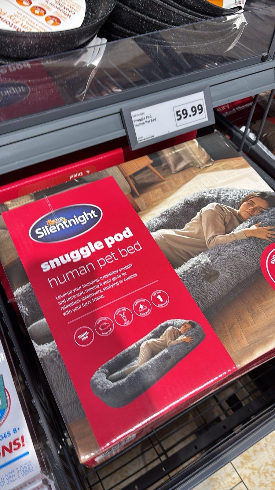 Packaging for a ‘human sized snuggle pod pet bed’ with an image showing a woman lying in what is clearly a huge dog bed